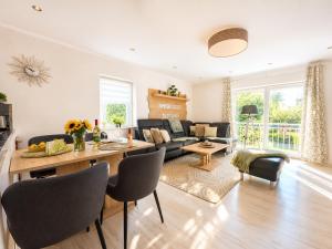 a living room with a couch and a table at Wellness Ferienhaus Garden in Michendorf +22 photos