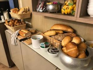 a table with a bunch of bread and pastries on it at Villa Amylia & gratis parking in Wenduine +13 photos