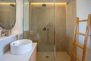 a bathroom with a sink and a shower at Akanthus Pirgos Bay in Malia