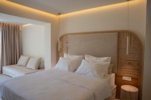 a hotel room with a bed and a window at Akanthus Pirgos Bay in Malia +14 photos