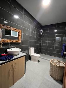 a bathroom with a toilet and a sink and a mirror at Blissful hill top Apartment in Praslin +27 photos