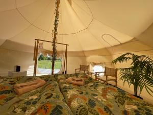 a bedroom with a bed in a tent at Galleriet BnB in Stenkyrka
