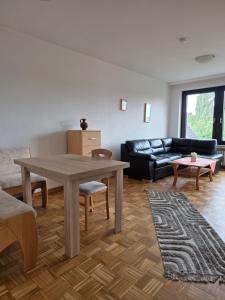 a living room with a table and a couch at Haus Steinmeyer in Bad Pyrmont