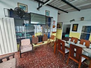a living room with a table and chairs and a clock at VILLA ELSA in El Colegio