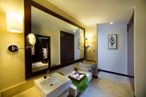 a bathroom with two sinks and a large mirror at Golden Palm Tree Sepang in Sepang