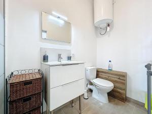 a bathroom with a toilet and a sink and a mirror at Studio avec terrasse en rez de chaussée in Lapalme