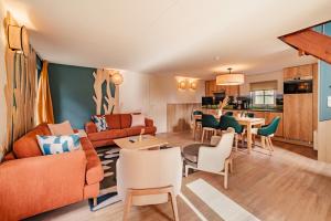 a living room with a couch and a table and chairs at Center Parcs Les Ardennes in Vielsalm