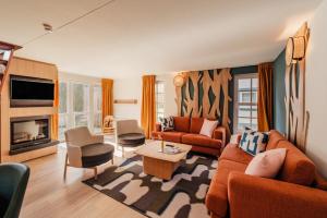 a living room with a couch and a table at Center Parcs Les Ardennes in Vielsalm