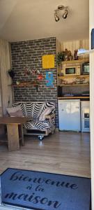 a kitchen with a table and a refrigerator at Guim appart in Guimiliau