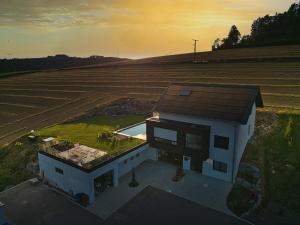 an aerial view of a house next to a field at BlackForestChillOut - Pool - Garten - BBQ - Sauna in Stühlingen