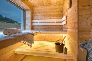 a sauna with a window in a wooden room at BlackForestChillOut - Pool - Garten - BBQ - Sauna in Stühlingen
