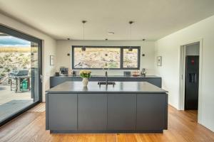 a kitchen with a large island with a sink at BlackForestChillOut - Pool - Garten - BBQ - Sauna in Stühlingen