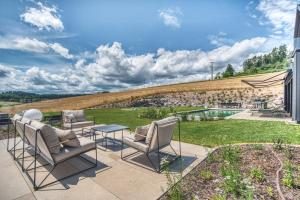 a patio with chairs and a table and a garden at BlackForestChillOut - Pool - Garten - BBQ - Sauna in Stühlingen +29 photos