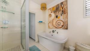 a white bathroom with a sink and a shower at 62 Camarque Umdloti Beachfront in Umdloti