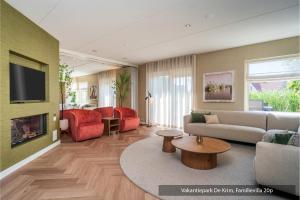 a living room with a couch and a fireplace at Vakantiepark De Krim Texel in De Cocksdorp
