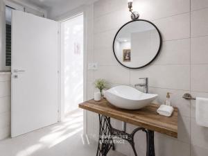 a bathroom with a sink and a mirror at Wanderlust Experience Loggiato del duca in Bitonto +20 photos
