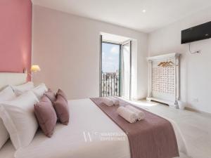 a bedroom with a large bed with a large window at Wanderlust Experience Loggiato del duca in Bitonto