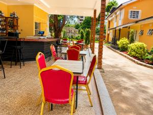 a restaurant with a table and chairs on a patio at Safari Resot Star One in Moshi