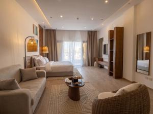 a living room with a couch and a bed at TIME Marina North Coast in El Alamein