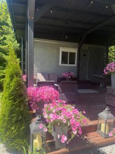 a porch with pink flowers and lights on it at Lumobile in Gryfice