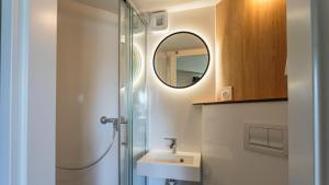 a bathroom with a shower and a sink and a mirror at Premiere Classe Bayonne in Bayonne +36 photos
