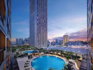 a view of a pool in a city with a tall building at Swissotel The Stamford Singapore in Singapore