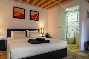 a bedroom with a bed with two bags on it at Casas Martinho - Algares in Piódão