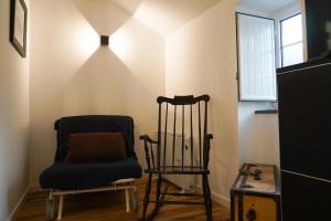 a room with two chairs and a window at Casas Martinho - Algares in Piódão