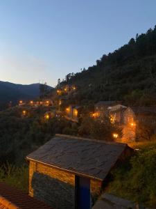 a night view of a village with lights at Casas Martinho - Algares in Piódão