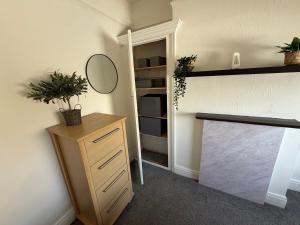 a room with a closet with a mirror and a dresser at 86 Watling in Gillingham