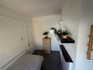 a bedroom with a bed and a dresser with a mirror at 86 Watling in Gillingham