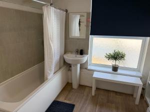 a bathroom with a sink and a window at 86 Watling in Gillingham