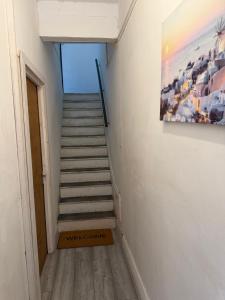 a staircase in a room with a painting on the wall at 86 Watling in Gillingham