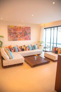 a living room with two couches and a painting at One Ocean Hotel Apartments by Nest & Nomad in Msambweni