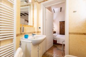 a bathroom with a sink and a mirror at BolognaRoomscom - Santo Stefano Apartments in Bologna +109 photos