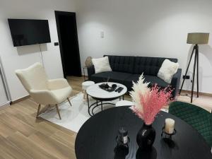a living room with a couch and a table at Bonaca Residence in Makarska