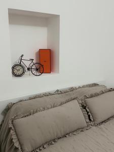 a bike is sitting on a wall above a bed at Bonaca Residence in Makarska