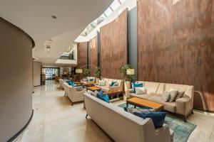 a lobby with couches and tables in a building at Hotel Constantine the Great in Belgrade