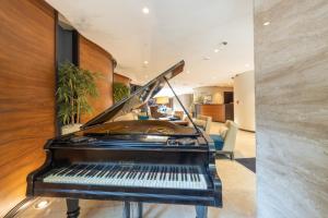 a piano in a living room with a staircase at Hotel Constantine the Great in Belgrade +24 photos