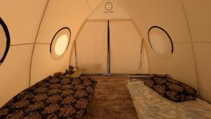 a room with two beds in a tent at Guest House of Issyk-Kul Camp in Chok-Tal