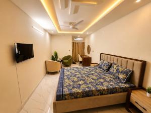 a bedroom with a bed and a living room at Motorway Majesty Heights - Near Islamabad International Airport and Motorway in Islamabad