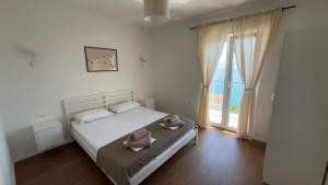 a bedroom with a bed with two towels on it at Apartmani Alexa 2 in Brist