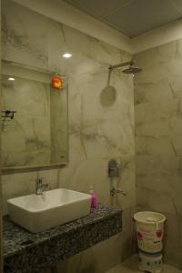a bathroom with a sink and a mirror at Hotel High Residency in New Delhi