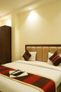 a hotel room with a bed with a towel on it at Hotel High Residency in New Delhi +18 photos
