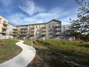 a apartment building with a walkway in front of it at DOMITYS - Les Cerfs-Volants in Berck-sur-Mer