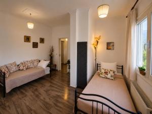 a living room with two beds and a window at Aposperitis in Amarynthos