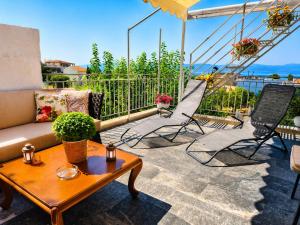 a living room with a couch and chairs on a balcony at Aposperitis in Amarynthos