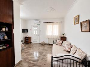 a living room with a couch and a table at Aposperitis in Amarynthos