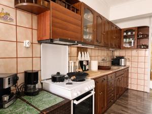 a kitchen with a white stove and wooden cabinets at Aposperitis in Amarynthos