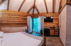 a bedroom with a bed in a room with wooden walls at Getahovit Resort in Ijevan